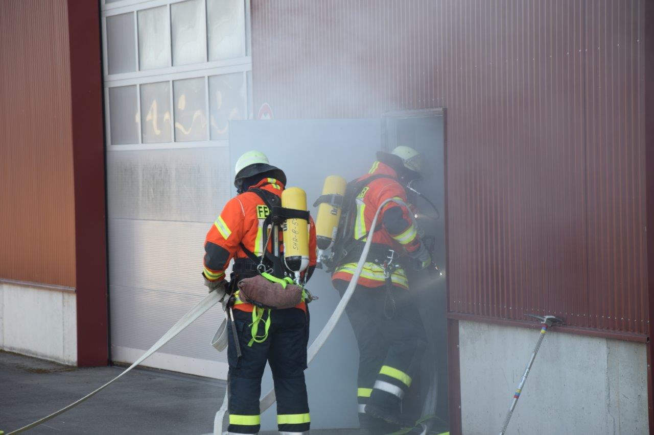 Die Angriffstrupps gehen unter Atemschutz zur Brandbekämpfung und Personensuche in das verrauchte Gebäude